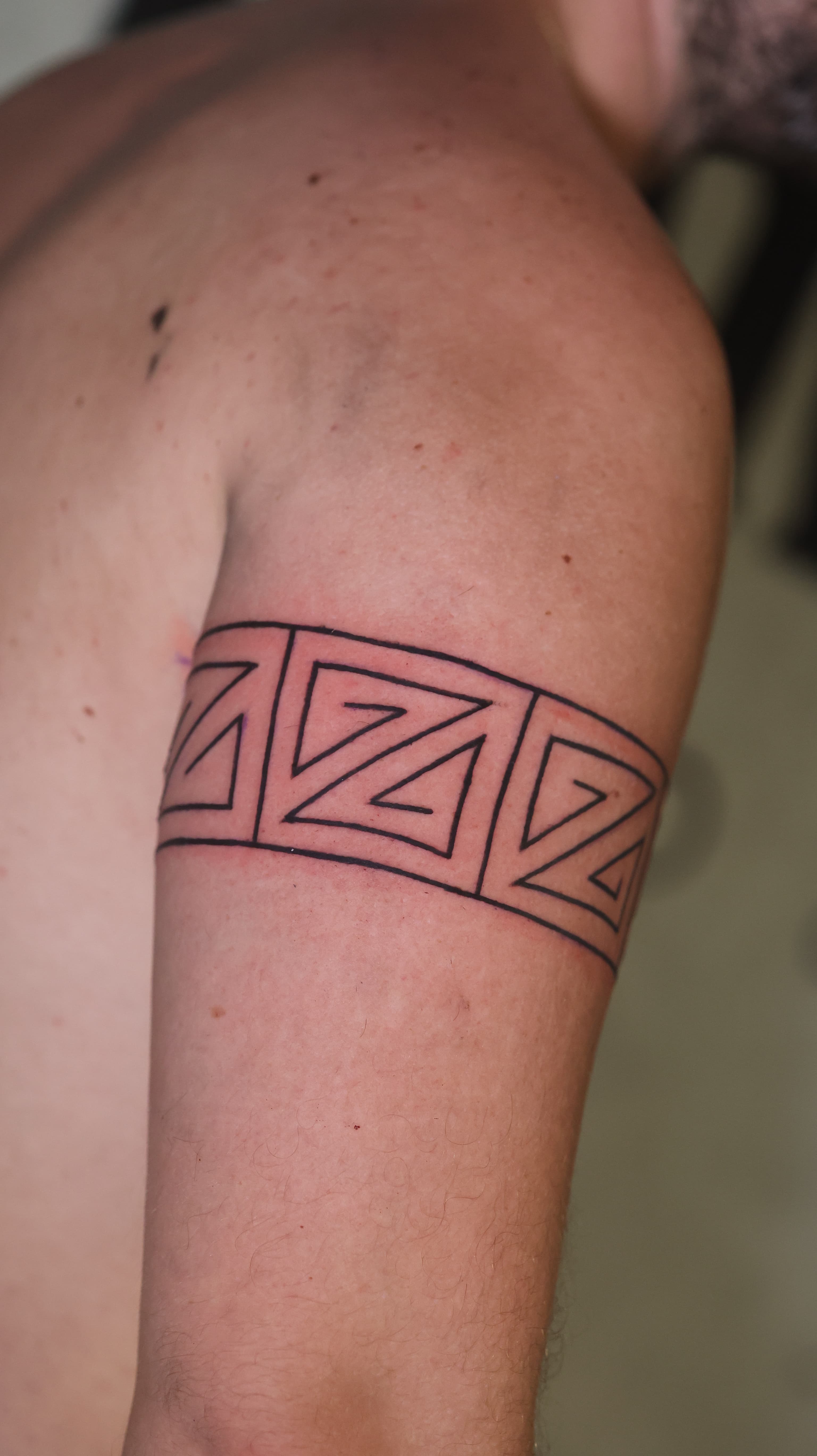 Geometric armband tattoo by Riverón at Pangea Ink