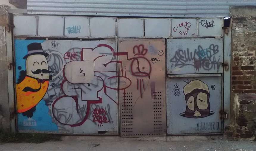 Graffiti gate with characters and throw-ups, signed ERNE, Cuba 2016